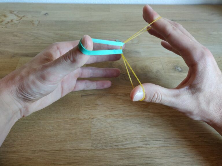 “Crazy Man’s Handcuffs”: Rubberband through rubberband trick