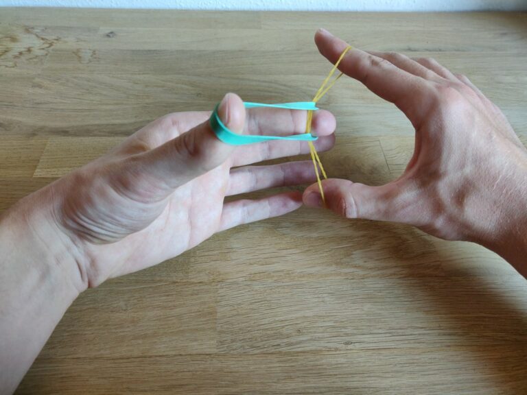 “Crazy Man’s Handcuffs”: Rubberband through rubberband trick