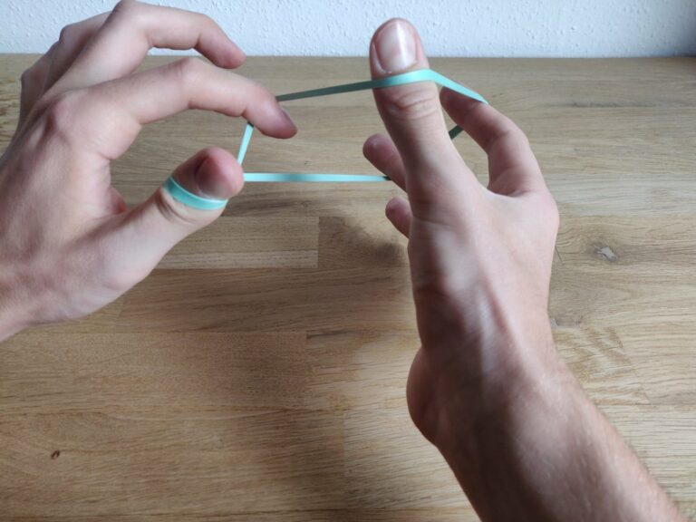 Rubber band through finger trick Tutorial with images