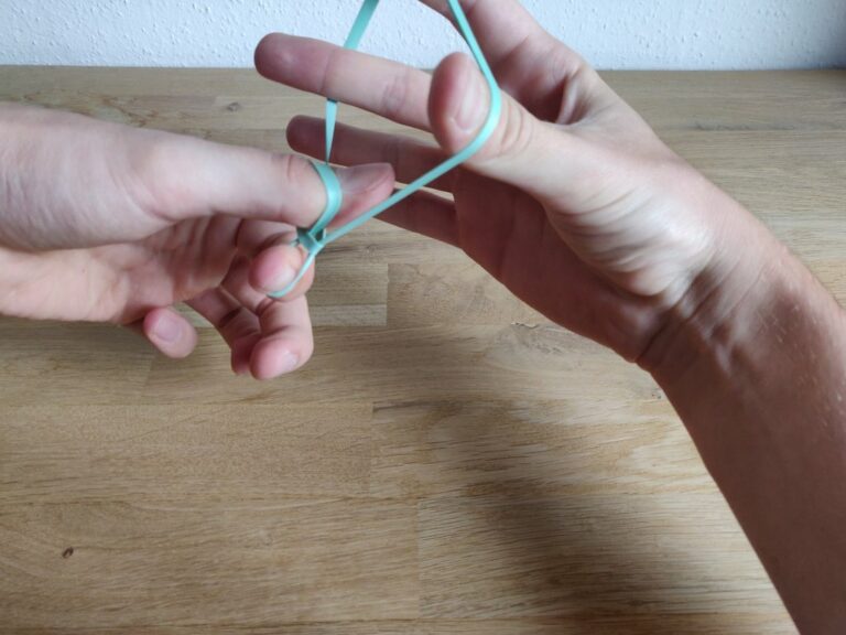 Rubber band through finger trick Tutorial with images