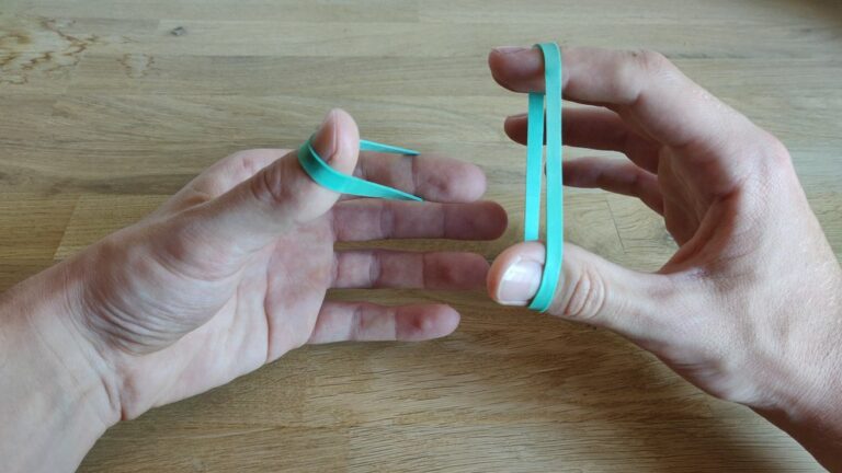 “Crazy Man’s Handcuffs”: Rubberband through rubberband trick